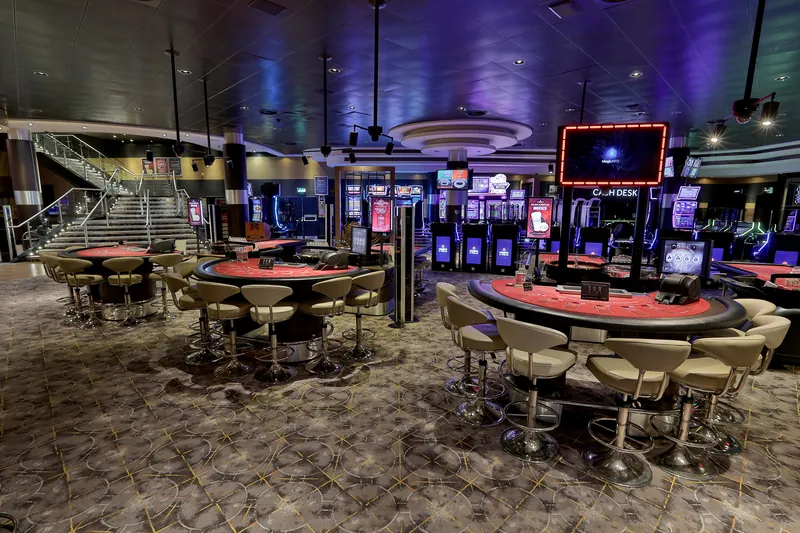 Gaming floor with tables and slot machines at Genting Casino Fountain Park