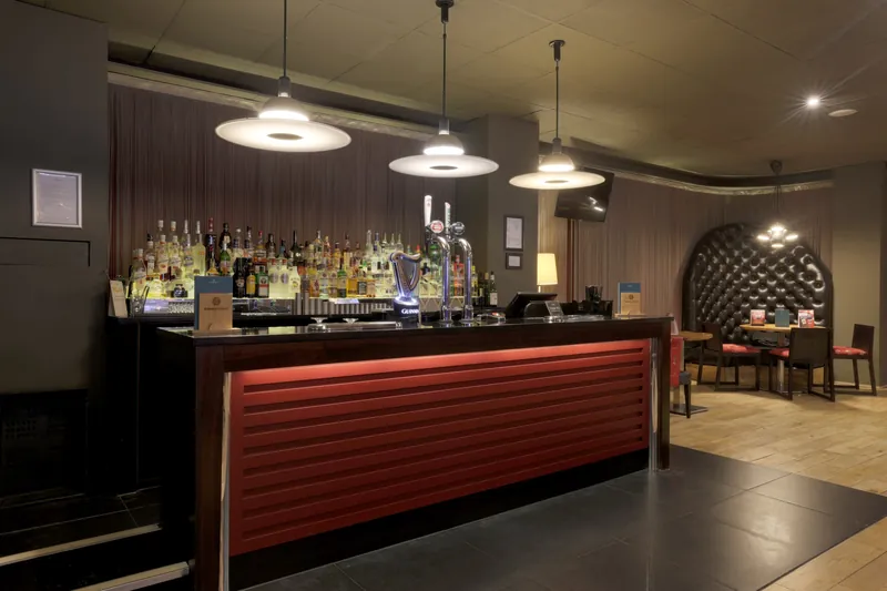 Bar area inside Genting Casino Plymouth with red counter and seating