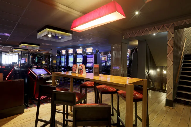 Slot machine area at Genting Casino Plymouth with high table seating