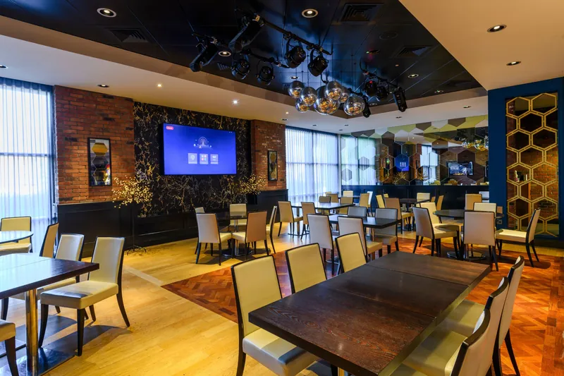 Dining room at Genting Casino Stoke with tables and brick walls