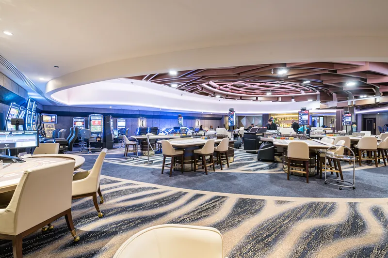 Gaming floor with tables and slot machines at The Colony Club