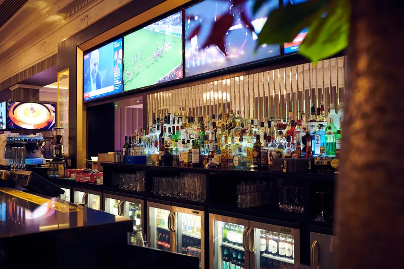 Bar area with screens inside The Palm Beach Casino