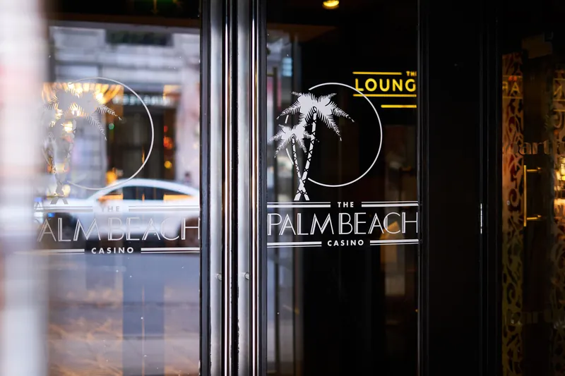 The Palm Beach Casino logo on glass door