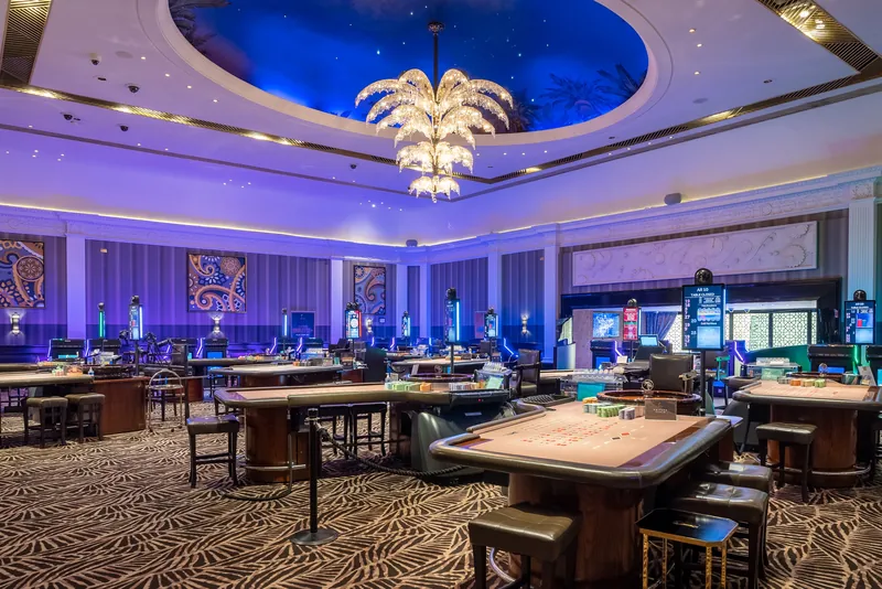 Gaming floor with table games at The Palm Beach Casino